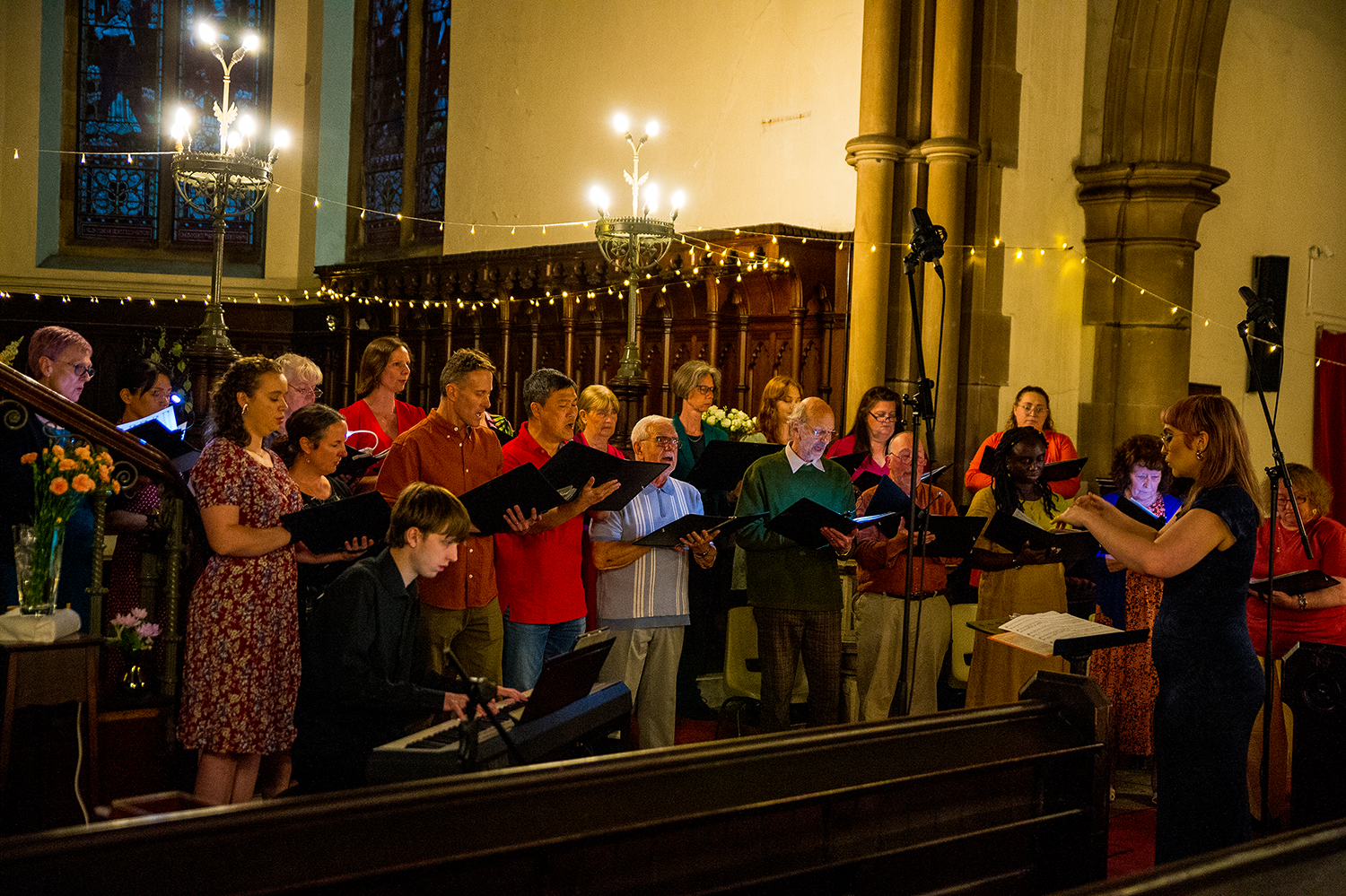 Vocal Sounds choir beneath the stained glass windows, Monton Unitarian Church